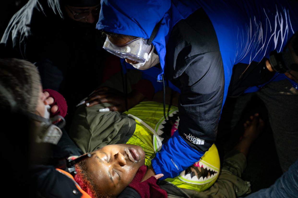 A demonstrator has a seizure during a standoff with police at a protest about Sunday's fatal shooting of Daunte Wright during a traffic stop outside the Brooklyn Center Police Department on Wednesday, April 14, 2021, in Brooklyn Center, Minn.