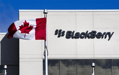 A Canadian flag waves in front of a Blackberry logo at the Blackberry campus in Waterloo, September 23, 2013. REUTERS/Mark Blinch