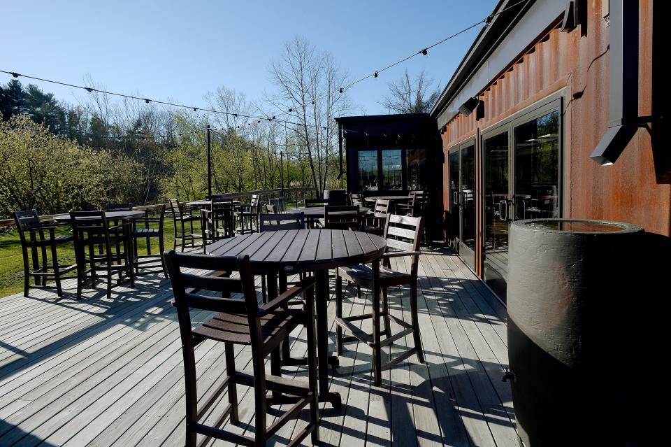 Smoky Park Supper Club is made out of shipping containers with a large outdoor patio facing the river. 