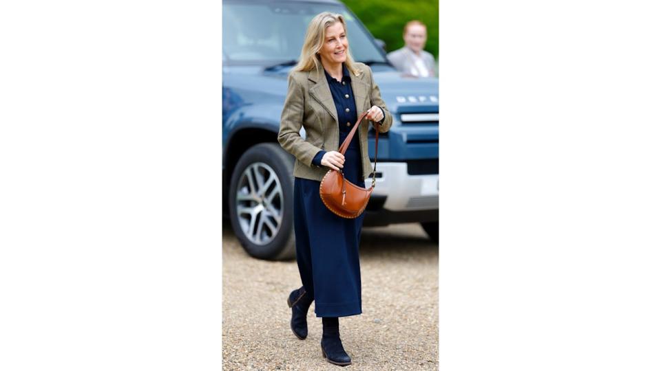 Duchess Sophie walking in navy dress and check blazer