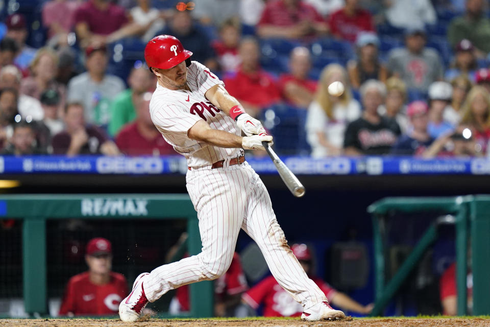 Philadelphia Phillies' J.T. Realmuto hits a double against Cincinnati Reds pitcher Reiver Sanmartin during the seventh inning of a baseball game, Wednesday, Aug. 24, 2022, in Philadelphia. (AP Photo/Matt Slocum)