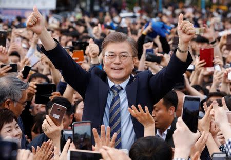 Moon Jae-in, the presidential candidate of the Democratic Party of Korea, is greeted by his supporters during his election campaign rally in Goyang, South Korea, May 4, 2017. REUTERS/Kim Hong-Ji
