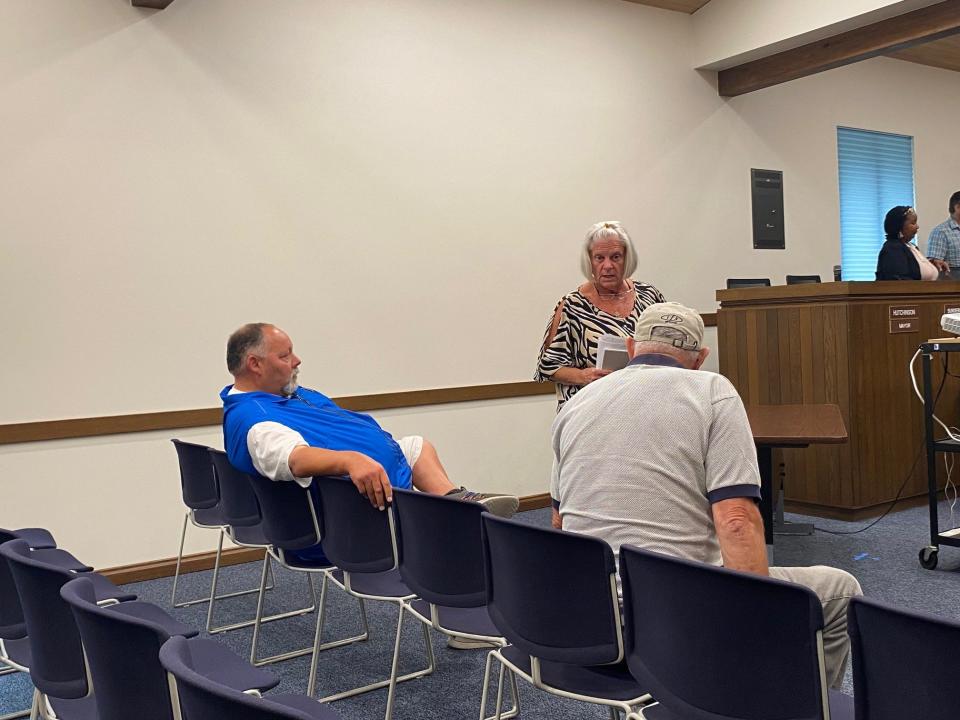 Ontario Auditor Mary Ann Hellinger, center, talks to resident Craig Hunt at right after the Ontario Council meeting. At left is Kenn Spencer, director of Ontario Youth Sports. Council is considering hiring OYS to become the Ontario Recreation Department director.