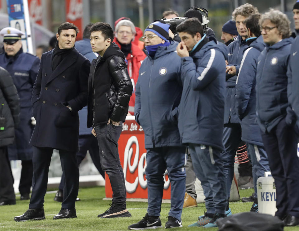 Inter Milan team's vice president Javier Zanetti, left, and Inter Milan's board of directors member, Zhang Steven, second from left, wait for the start of the Serie A soccer match between Inter Milan and Chievo, at Milan's San Siro stadium, Italy, Saturday, Jan. 14, 2017. (AP Photo/Luca Bruno)