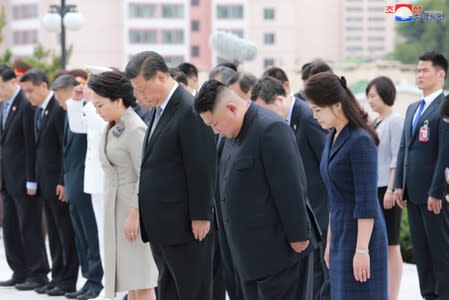 Chinese President Xi Jinping, his wife Peng Liyuan, North Korean leader Kim Jong Un and his wife Ri Sol Ju are seen during Xi's visit in Pyongyang