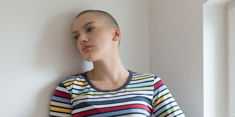 woman with bald head suffering from cancer ready to leave hospital after chemotherapy