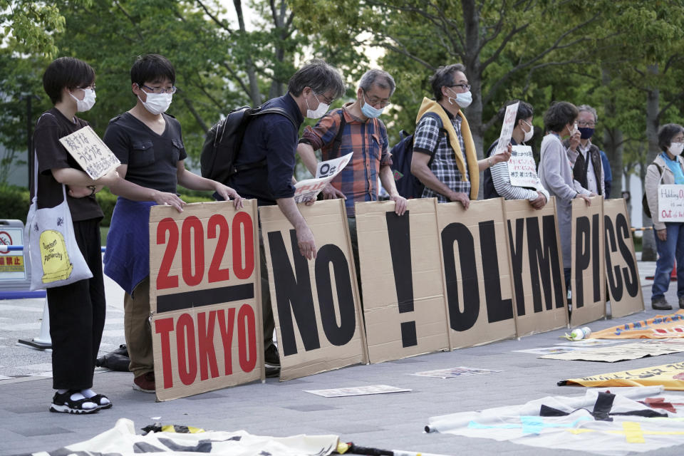 People against the Tokyo 2020 Olympics set to open in July, protest around Tokyo's National Stadium during an anti-Olympics demonstration Sunday, May 9, 2021. (AP Photo/Eugene Hoshiko)