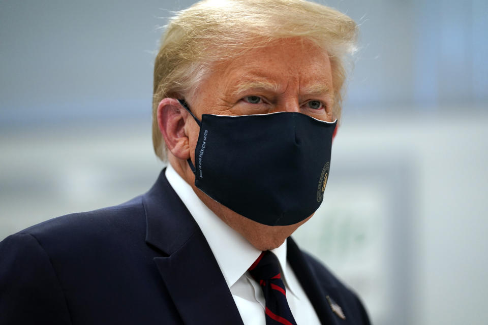 President Donald Trump wears a face mask as he participates in a tour of Bioprocess Innovation Center at Fujifilm Diosynth Biotechnologies, Monday, July 27, 2020, in Morrisville, N.C. (AP Photo/Evan Vucci)