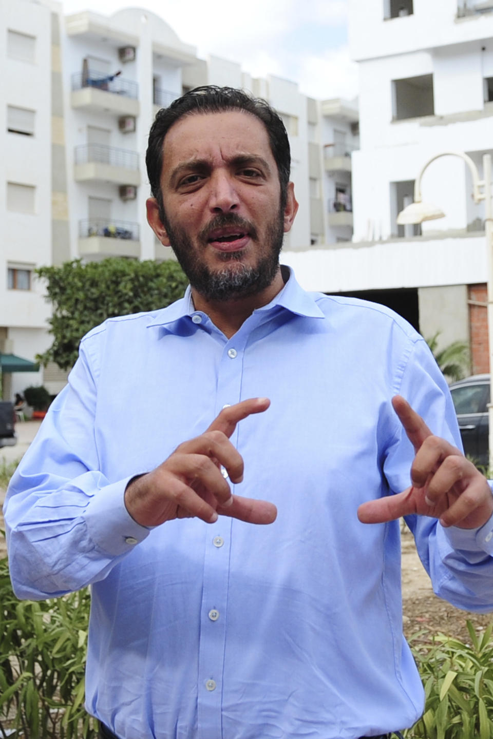 Yassine Ayari reacts during an interview in Tunis, Tuesday, Oct.12, 2021. Ayari, a 40-year-old Tunisian computer engineer turned corruption fighter, will stand trial again in a military court Monday Sept. 22. He is accused of insulting the presidency and defaming the army. It is the latest in a series of trials that shine a light on Tunisia’s use of military courts to push through convictions against civilians. (AP Photo/Hassene Dridi)