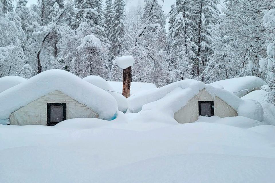 In this photo provided by the National Park Service, tents at Curry Village are covered with snow in Yosemite National Park, Calif., Tuesday, Feb. 28, 2023. The park, closed since Saturday because of heavy, blinding snow, postponed its planned Thursday, March 2, 2023, reopening indefinitely. (National Park Service via AP) ORG XMIT: FX308