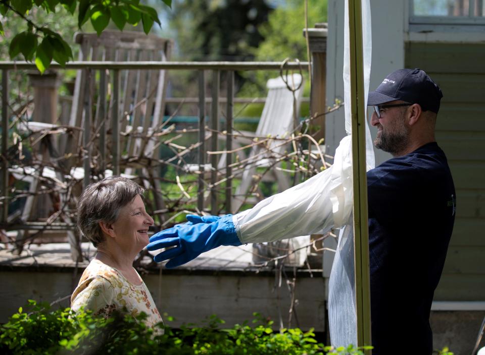 Alex Montagano demonstrates his "Hugging Station" with neighbour Sharon Pearce-Anderson, that he built to embrace family members amid the coronavirus disease (COVID-19) precautions in Montreal, Quebec, Canada May 21, 2020.