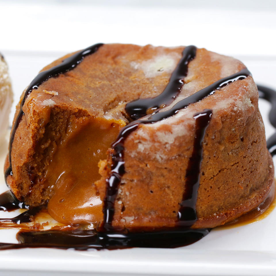 Rich lava cake with oozing caramel at the center and drizzled with chocolate sauce