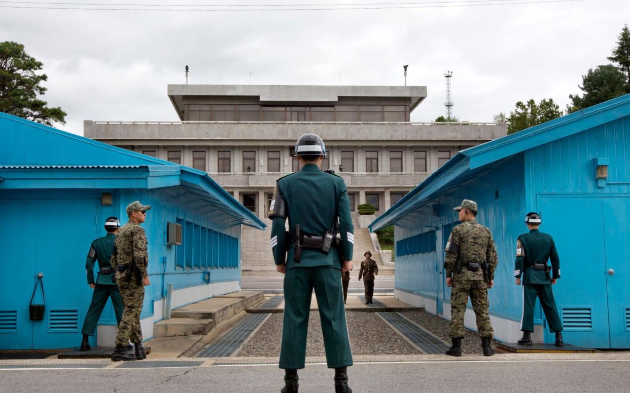 South Korean soldiers look toward the North Korean side at the military border - AP POOL