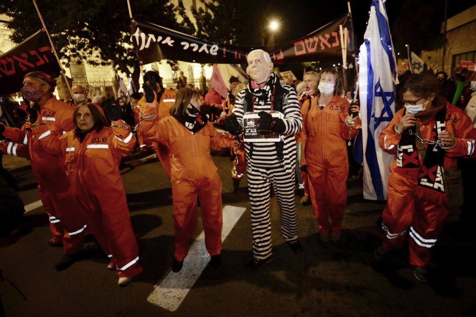 Israeli protesters chant slogans during a demonstration against Israeli Prime Minister Benjamin Netanyahu In Jerusalem, Saturday, Jan. 23, 2021. (AP Photo/Sebastian Scheiner)