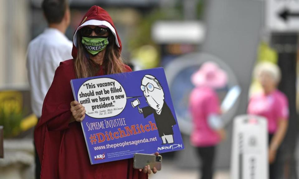 A protester dressed as a handmaiden stands outside the venue in Louisville.