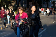 <p>People walk down the center of a street in the Roma neighborhood after an earthquake shook Mexico City, Friday, Feb. 16, 2018. (Photo: Rebecca Blackwell/AP) </p>