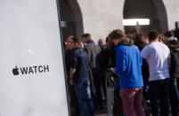 An Apple Watch logo is seen in front of an Apple Store as customers and journalists wait to enter, in Berlin April 10, 2015. REUTERS/Stefanie Loos