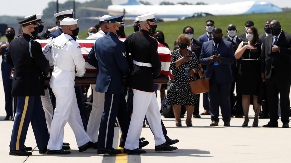 The flag-draped casket of Rep. John Lewis, D-Ga., is carried by a joint services military honor guard to a hearse at Andrews Air Force Base, Md. , on Monday. (AP Photo/Alex Brandon, Pool)