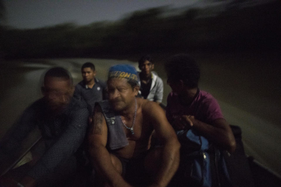 In this Sept. 3, 2019 photo, indigenous leader Emilio Tembé, center, returns by boat to his village after a meeting of Tembé tribes at the Tekohaw indigenous reserve, Para state, Brazil. Brazil’s 900,000 indigenous people make up about 5% of the country’s percent of all of the population and their reservations account for about 14 percent of the country. (AP Photo/Rodrigo Abd)