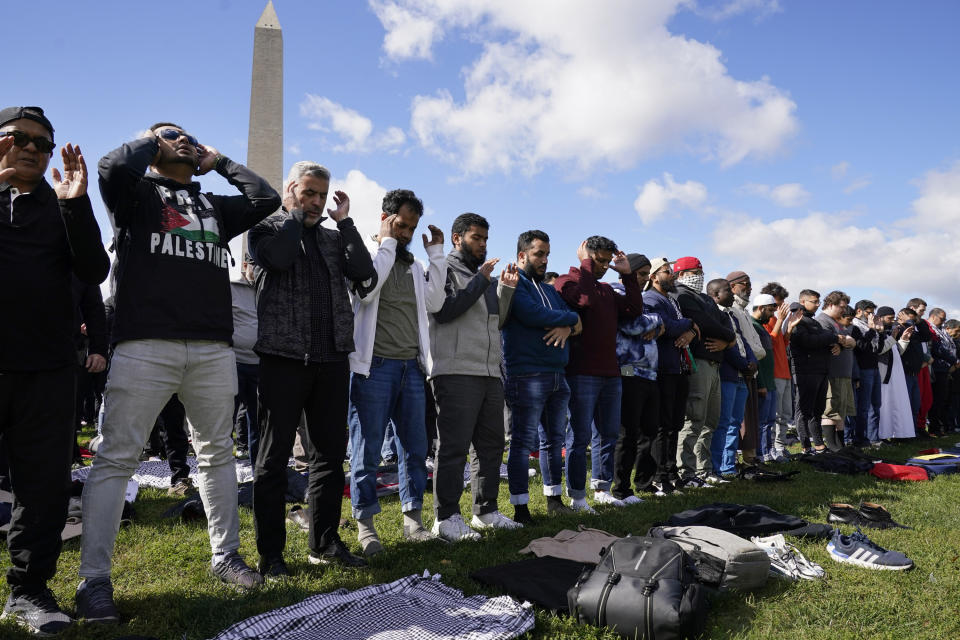 People pray during a rally calling for a cease-fire in Gaza at the Washington Monument, Saturday, Oct. 21, 2023, in Washington. (AP Photo/Andrew Harnik)