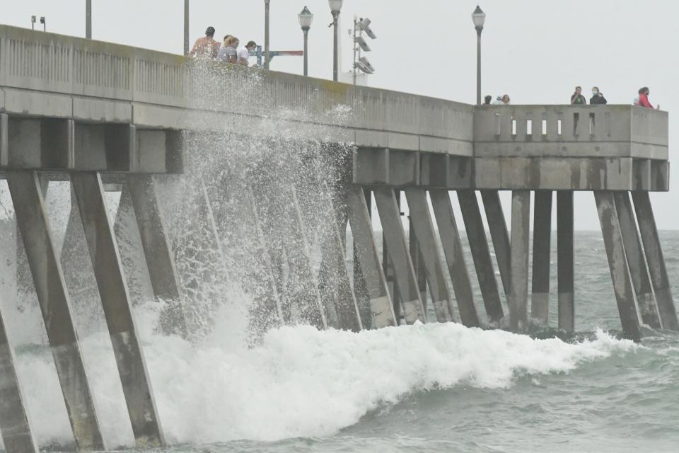 Beachgoers check out the waves at Wrightsville Beach, N.C. near Johnnie Mercers Fishing Pier as Tropical Storm Isaias moves towards North Carolina Monday Aug. 3, 2020. Wrightsville Bech is nominated for USA TODAY 10Best Readers' Choice 2024 best beach in North Carolina.