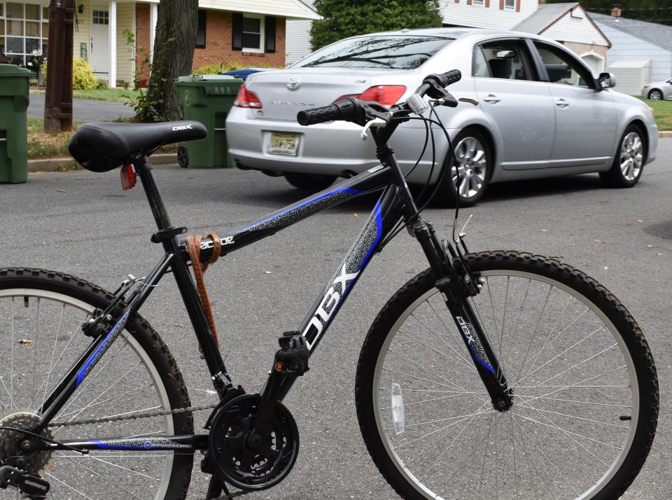 A vehicle passes a bicycle left by the side of a South Jersey road.