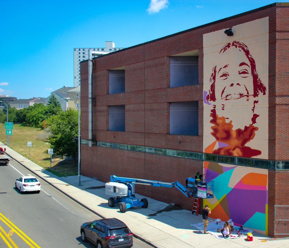 A mural of a Doran Community School student takes shape on the rear of the building, on July 22, 2022. It is being created by artist Kevin Ledo of Montreal.