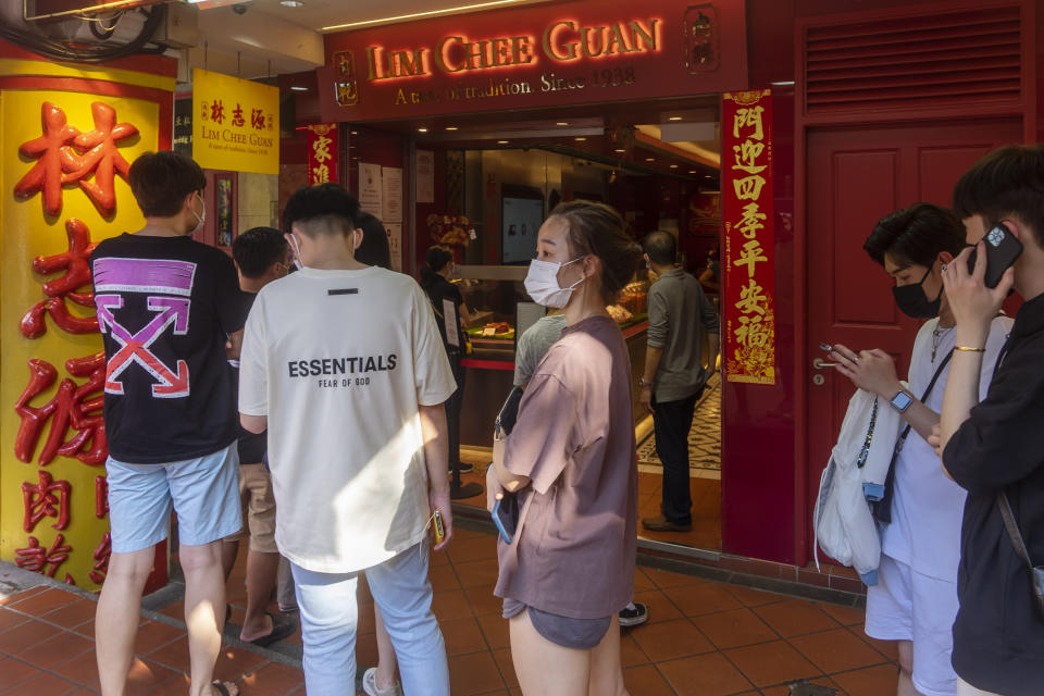 Singapore, Singapore - January 9, 2022: Shoppers queue outside the flagship Lim Chee Guan store in Chinatown to purchase 'bak kwa', or barbecued sliced pork, close to Lunar New Year. (Photo: Getty)