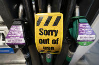 An out of use sign is seen on a pump at a petrol station after the current outbreak of fuel panic buying in the UK, in Manchester, England Monday, Sept. 27, 2021. British Prime Minister Boris Johnson is said to be considering whether to call in the army to deliver fuel to petrol stations as pumps ran dry after days of panic buying. ( AP Photo/Jon Super)