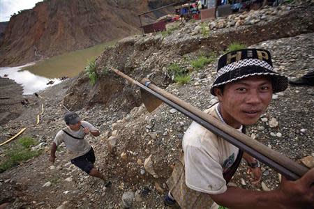 Hand-pickers return from searching for jade through rubble dumped by mining companies at a jade mine in Hpakant township, Kachin State July 7, 2013. REUTERS/Minzayar