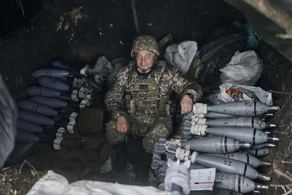 A Ukrainian soldier sits in shelter as he prepare fire the Russian positions with the mortar in Bakhmut, Donetsk region, Ukraine, Friday, Oct. 21, 2022. (AP Photo/LIBKOS)