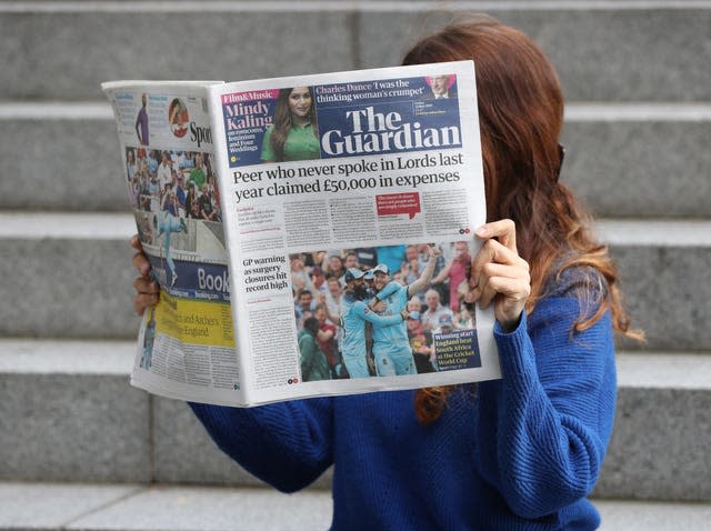 A person reading The Guardian