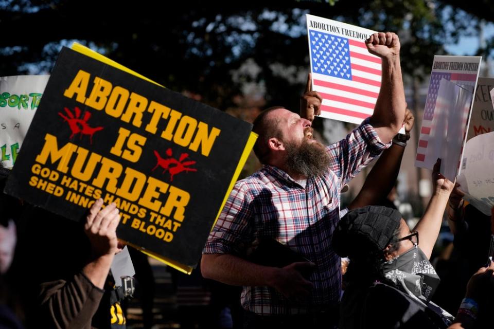 Allen Siders, an anti-abortion activist, calls out to speakers at an abortion rights rally in Jackson, Mississippi on Wednesday (AP)