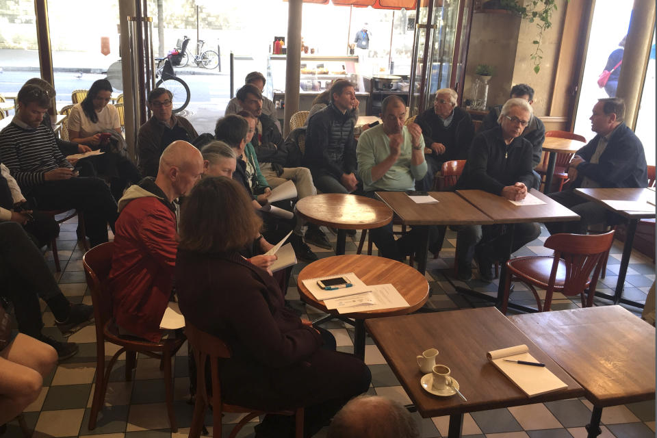 Members of Notre Dame neighborhood merchants' association gather at Quasimodo Notre Dame cafe in Paris, Thursday, April 18, 2019. Since Monday's fire, half the island in the middle of the Seine has been closed to visitors. Residents who had never met before suddenly find themselves the only customers of restaurants and cafés normally filled with tourists. At Quasimodo Notre Dame bar, named for Victor Hugo's hunchback, storekeepers commiserate. (AP Photo/Nicolas Vaux-Montagny)
