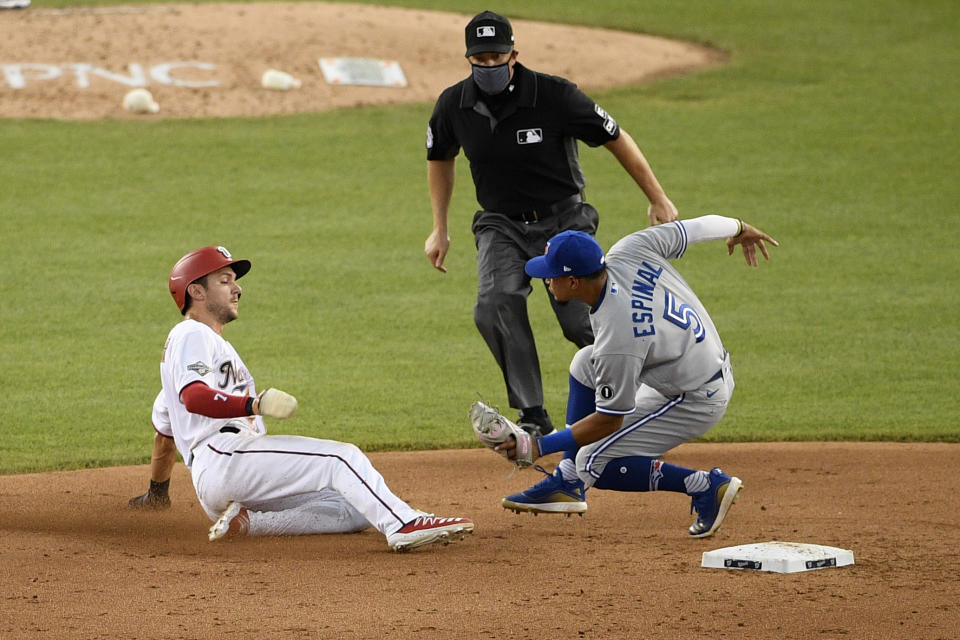 Washington Nationals' Trea Turner, left, is out as he tries to steal second base against Toronto Blue Jays shortstop Santiago Espinal (5) during the sixth inning of a baseball game, Tuesday, July 28, 2020, in Washington. The Blue Jays won 5-1. (AP Photo/Nick Wass)
