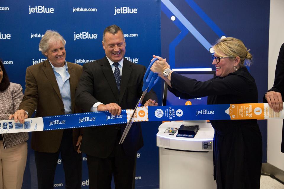JetBlue's Joanna Geraghty cuts the ribbon at the self-service lobby at JFK's Terminal 5 on July 14, 2016.