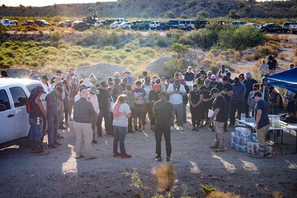 Robinson, a Christian, prays with volunteers before they search for Daniel.