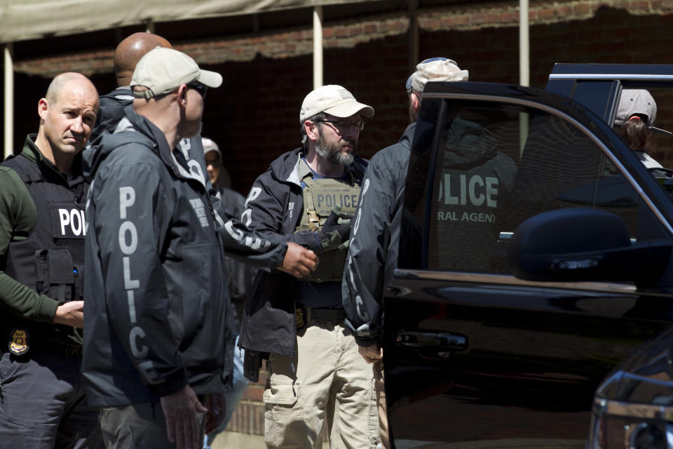 Federal agents walk out of the Venezuelan Embassy after arresting pro Nicolas Maduro supporters during a eviction from the Venezuelan Embassy in Washington, Thursday, May 16, 2019. . (AP Photo/Jose Luis Magana)