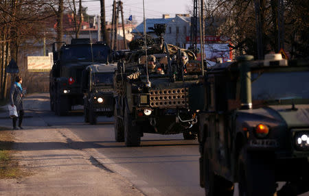 A convoy of troops, a part of NATO's reinforcement of its eastern flank, who are on their way from Germany to Orzysz in northeast Poland, drives through Sulejowek towards a military base in Wesola, near Warsaw, Poland, March 28, 2017. REUTERS/Kacper Pempel