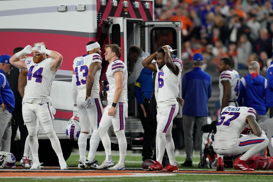 Buffalo Bills players react as teammate Damar Hamlin is examined during the first half of an NFL football game against the Cincinnati Bengals, Monday, Jan. 2, 2023, in Cincinnati. (AP Photo/Jeff Dean)