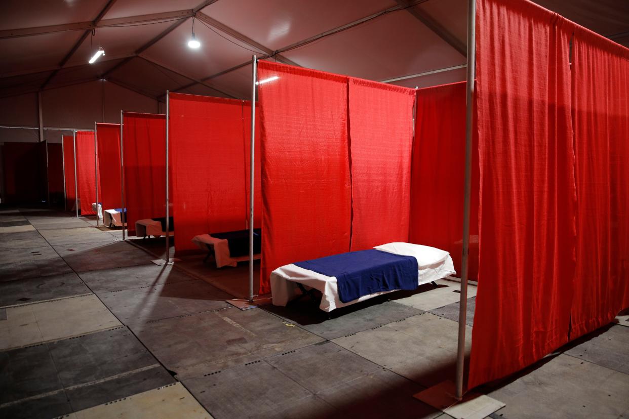 Beds fill a structure at a coronavirus isolation and quarantine complex for the homeless on Monday, April 13, 2020, in Las Vegas. The facility, scheduled to open Monday evening, was built to house homeless with suspected or confirmed cases of coronavirus that don't require hospitalization.