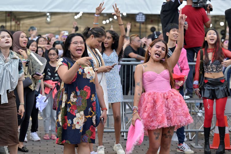 Taylor Swift's fans, or Swifties, sing and dance to her music at the National Stadium for Swift's Eras Tour concert in Singapore