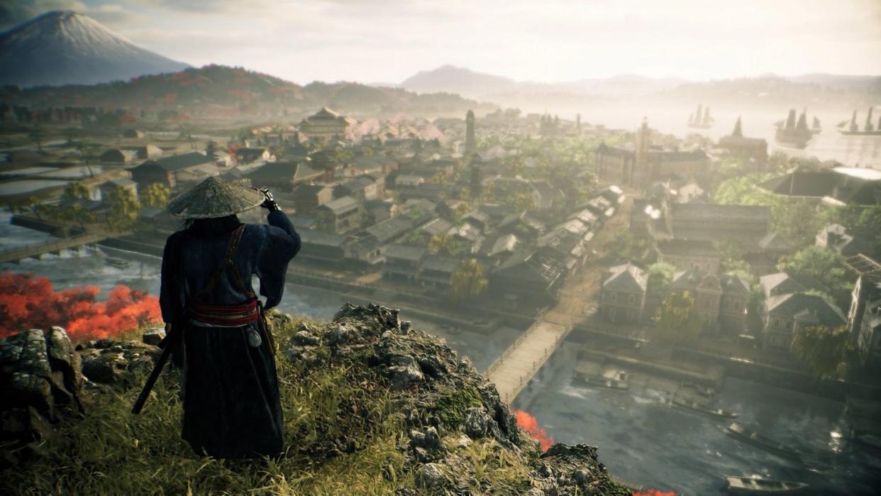  A character overlooking a populated location in Rise of the Rōnin. 