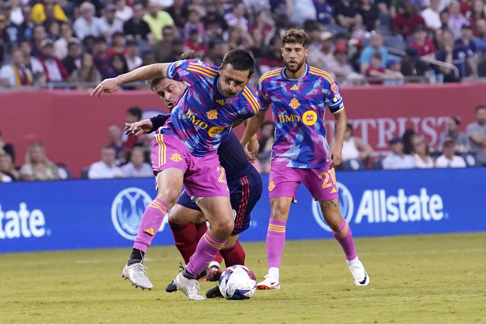 Toronto FC defender Shane O'Neill, front left, cuts Chicago Fire midfielder Xherdan Shaqiri, back left, off from the ball during the first half of an MLS soccer match Saturday, July 15, 2023, in Chicago. (AP Photo/Charles Rex Arbogast)