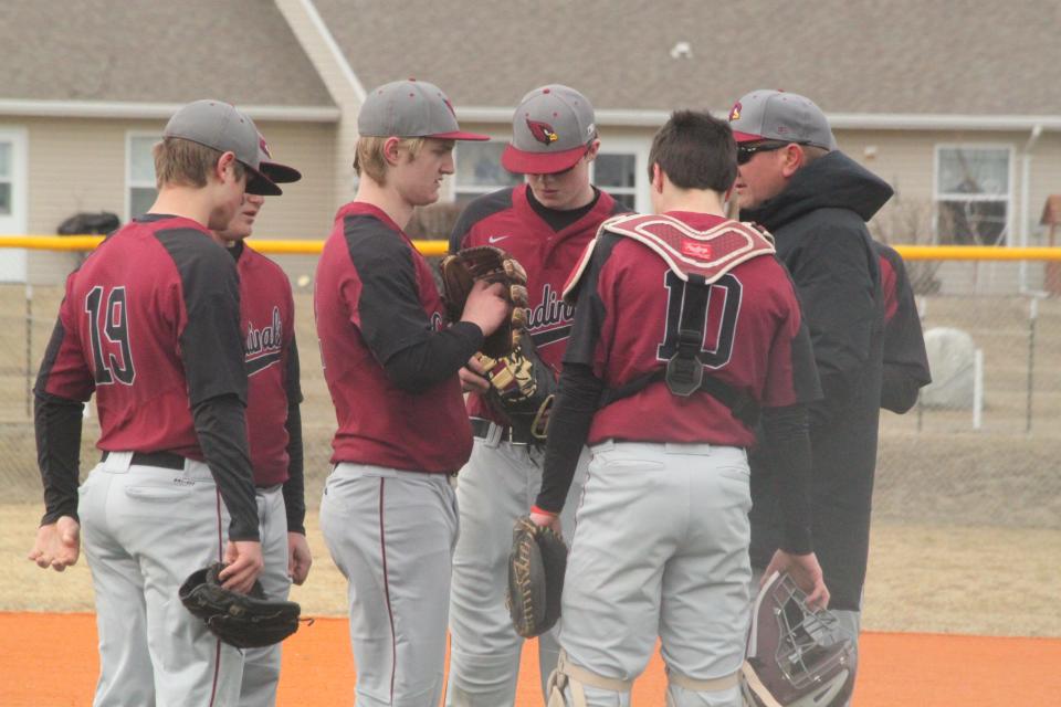 The Langdon Area/Edmore/Munich Cardinals huddle together on April 9.