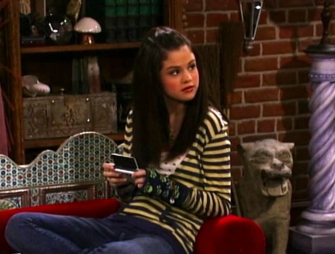 Selena wearing a striped long-sleeved shirt and jeans