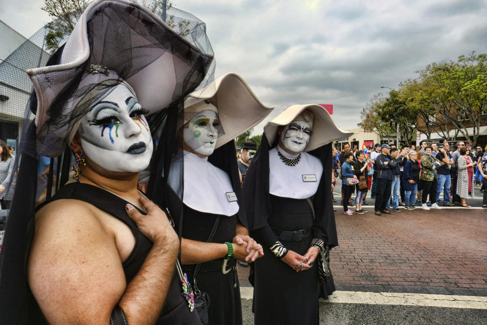 FILE - Members of the Sisters of Perpetual Indulgence attend a gay Pride parade in West Hollywood, Calif., on Sunday, June 12, 2016. Three prominent Catholic leaders — including the archbishops of New York and Los Angeles — said the Los Angeles Dodgers should have stuck by its short-lived decision to exclude the satirical LBGTQ+ group from the 2023 Pride Night because it features men dressed flamboyantly as nuns. Under fire from LGBTQ+ activists, the team re-invited the group. (AP Photo/Richard Vogel, File)