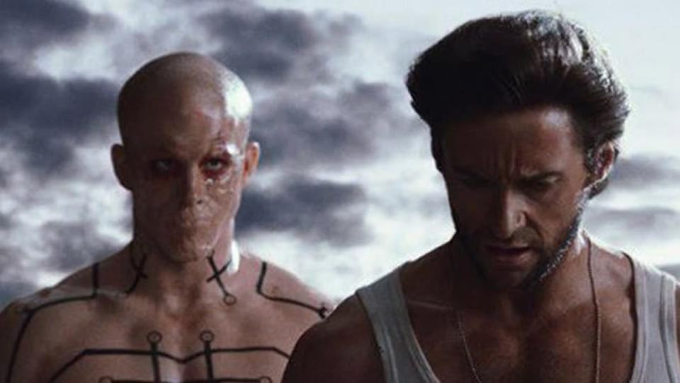 Mouthless, bald Ryan Reynolds stands behind Hugh Jackman in X-Men Origins: Wolverine.