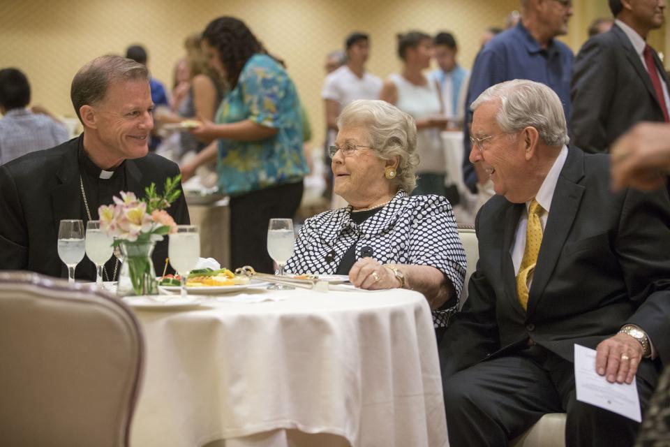 Bishop John C. Wester, left, talks with Sister Barbara and Elder M. Russell Ballard Sunday, May 31, 2015, during a farewell reception at Little America Hotel as he prepares to become Archbishop of Santa Fe. | Scott G Winterton, Deseret News