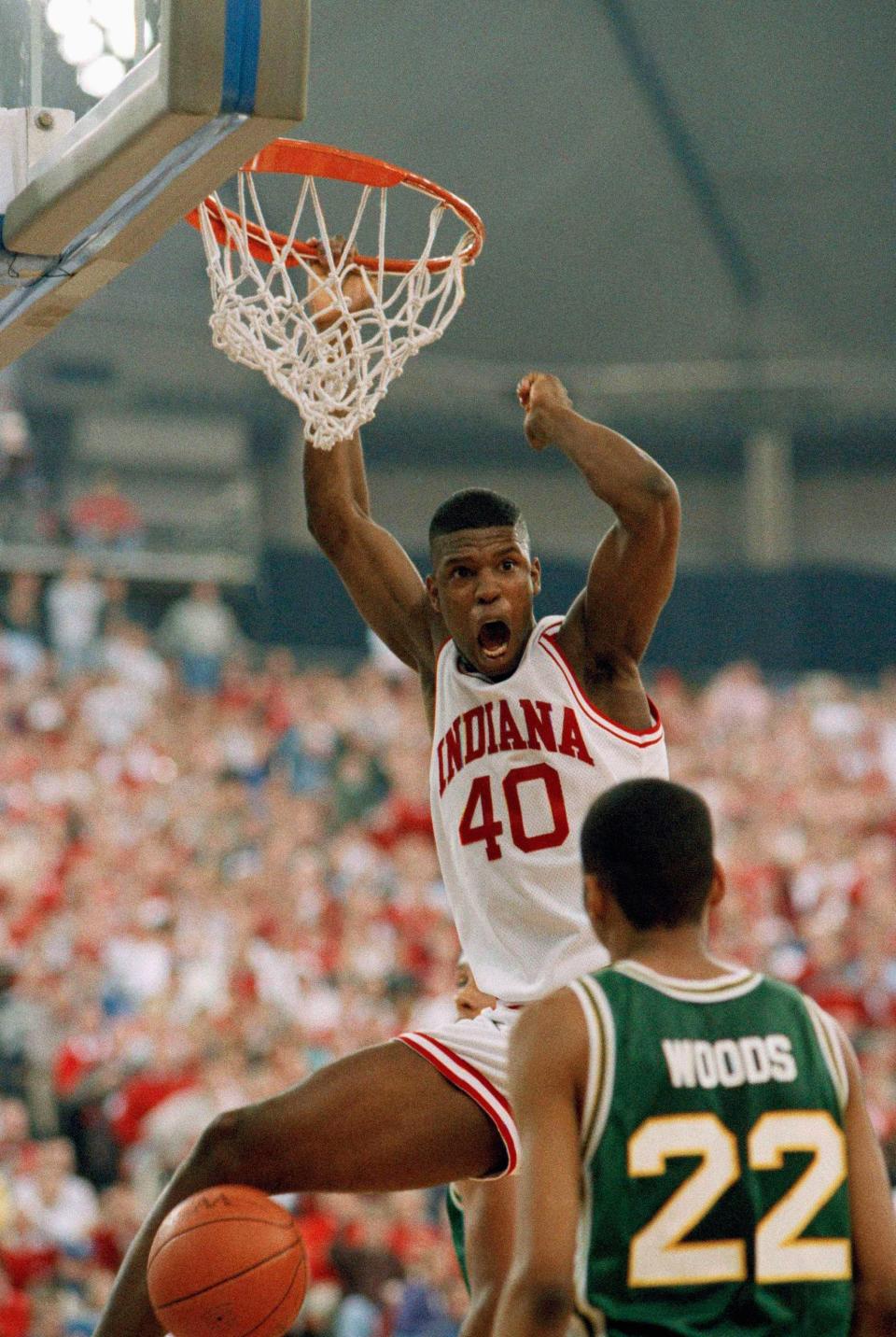 Indiana forward Calbert Cheaney dunks the ball against Wright State defender Mark Woods during their first-round NCAA tournament game in Indianapolis, March 19, 1993.